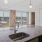 Spacious and well lit kitchen with wood floors and black appliances 