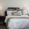 Spacious and well lit bedroom with plush carpet and large windows